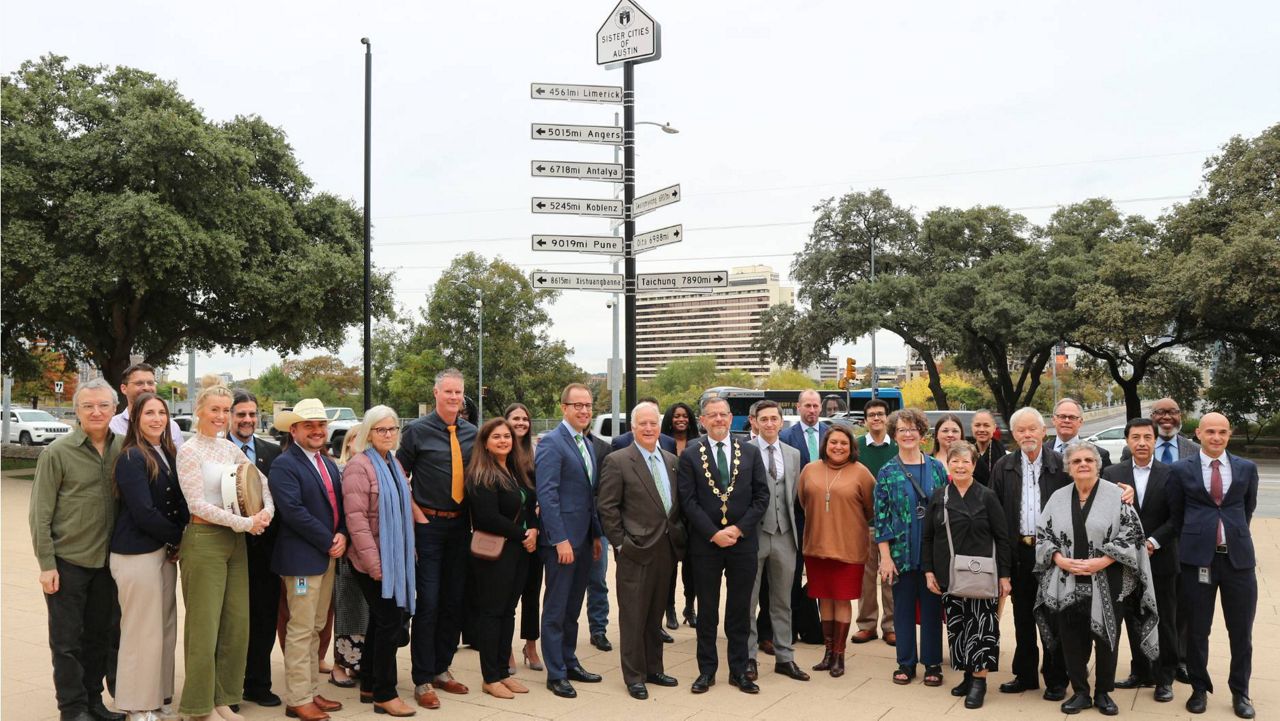 Austin and Limerick, Ireland, officials stand in front of Austin City Hall for the unveiling of Limerick being added to the sister cities sign on Thursday, Dec. 5, 2024. (Courtesy City of Austin)