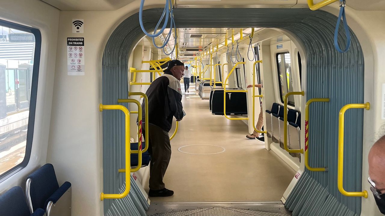 The cars are roomy and lightly air-conditioned with disability accessible seating and rack space for luggage. (Spectrum News/Michael Tsai)