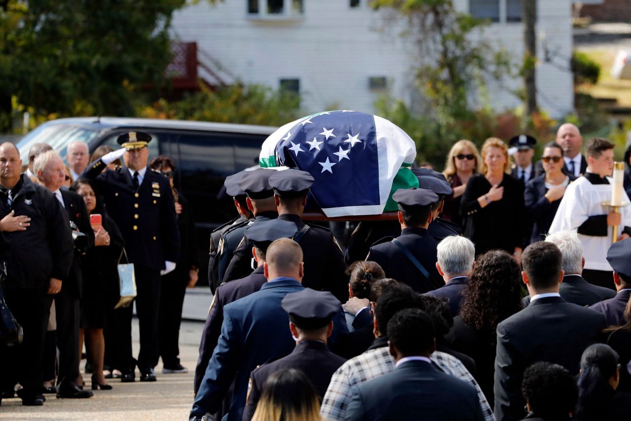 NYPD officer killed by friendly fire is hailed as a hero