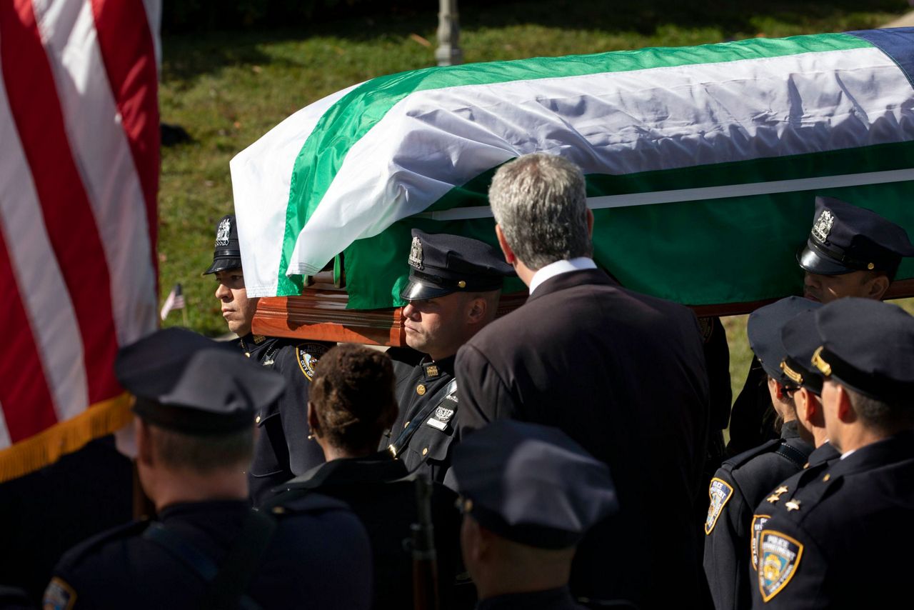 NYPD officer killed by friendly fire is hailed as a hero