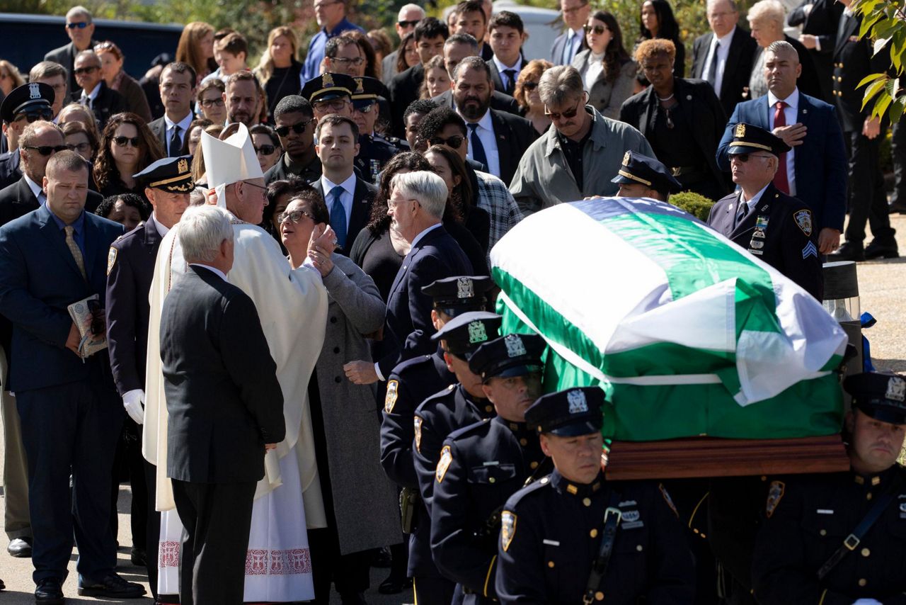 NYPD officer killed by friendly fire is hailed as a hero