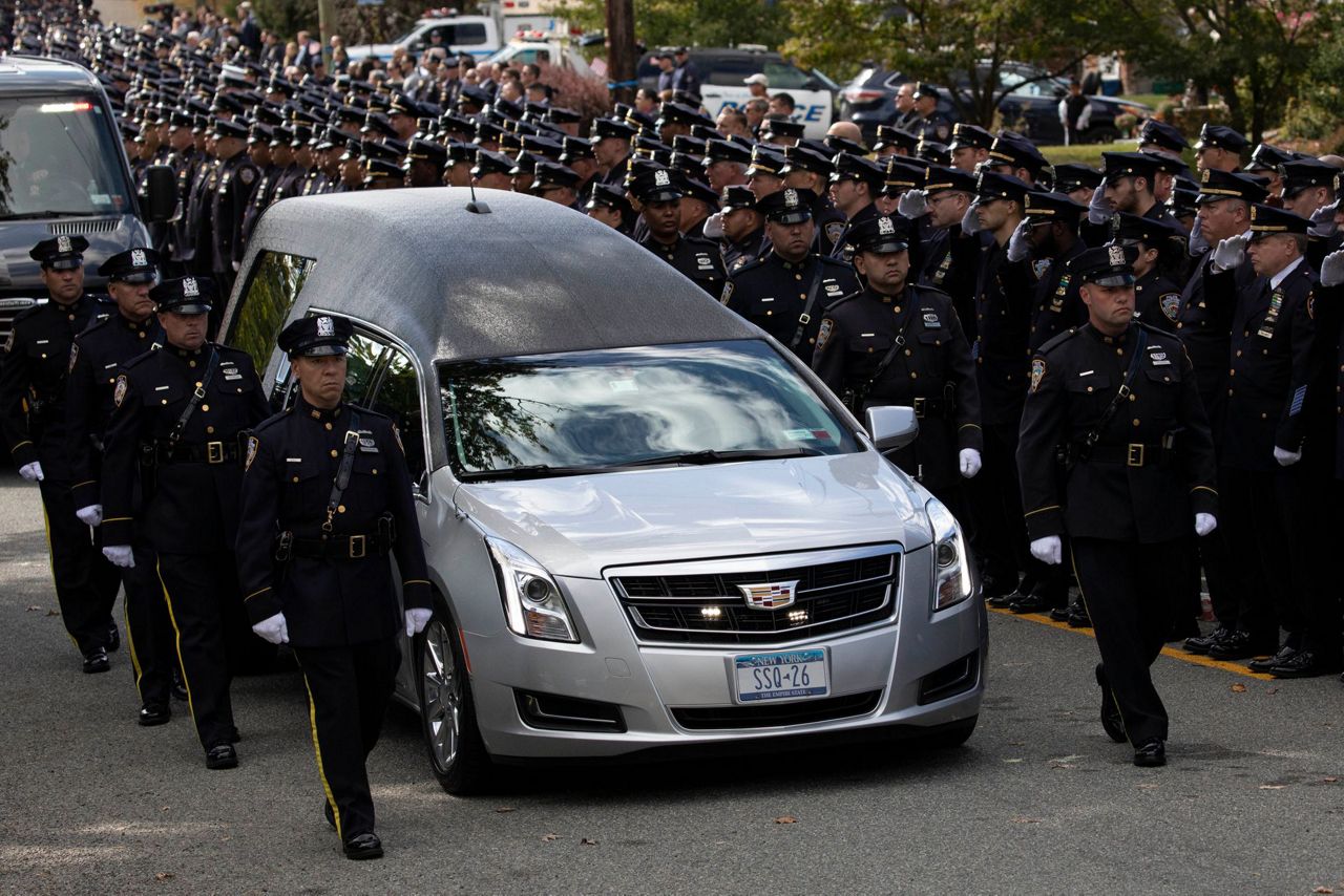 NYPD officer killed by friendly fire is hailed as a hero