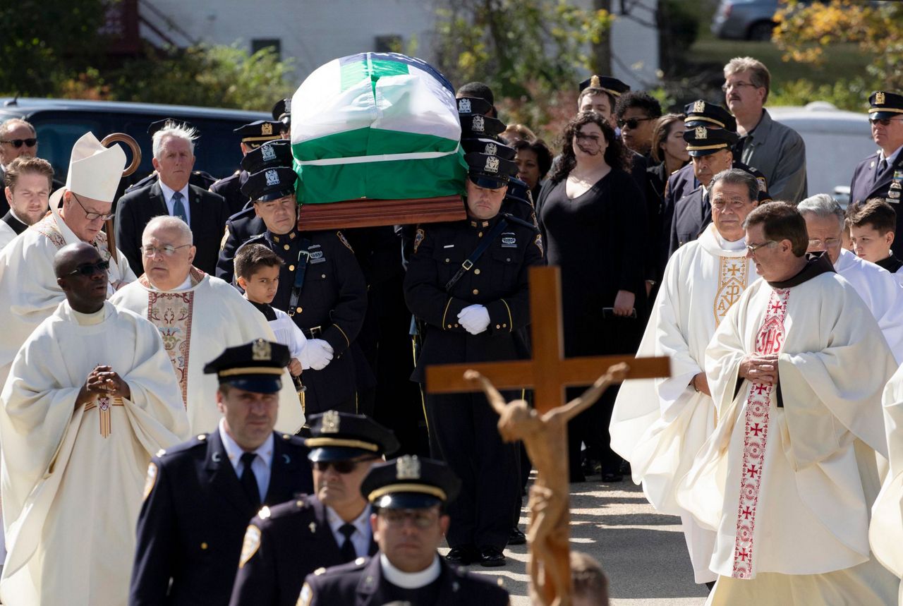 NYPD officer killed by friendly fire is hailed as a hero