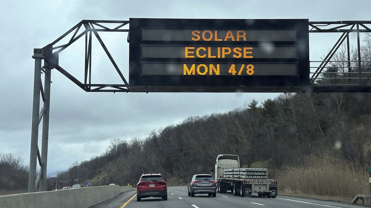 A Solar Eclipse sign is on Interstate 81 in Binghamton, New York, on Thursday, April 4, 2024. The highway leads to areas of the state that are in the path of totality. If clouds don't get in the way, viewers in the path wearing eclipse glasses will see the moon begin to slowly cover the sun until it is completely blocked, a period of darkness called totality, during which temperatures drop and the sun's corona will be visible. (AP PhotoTed Shaffrey)