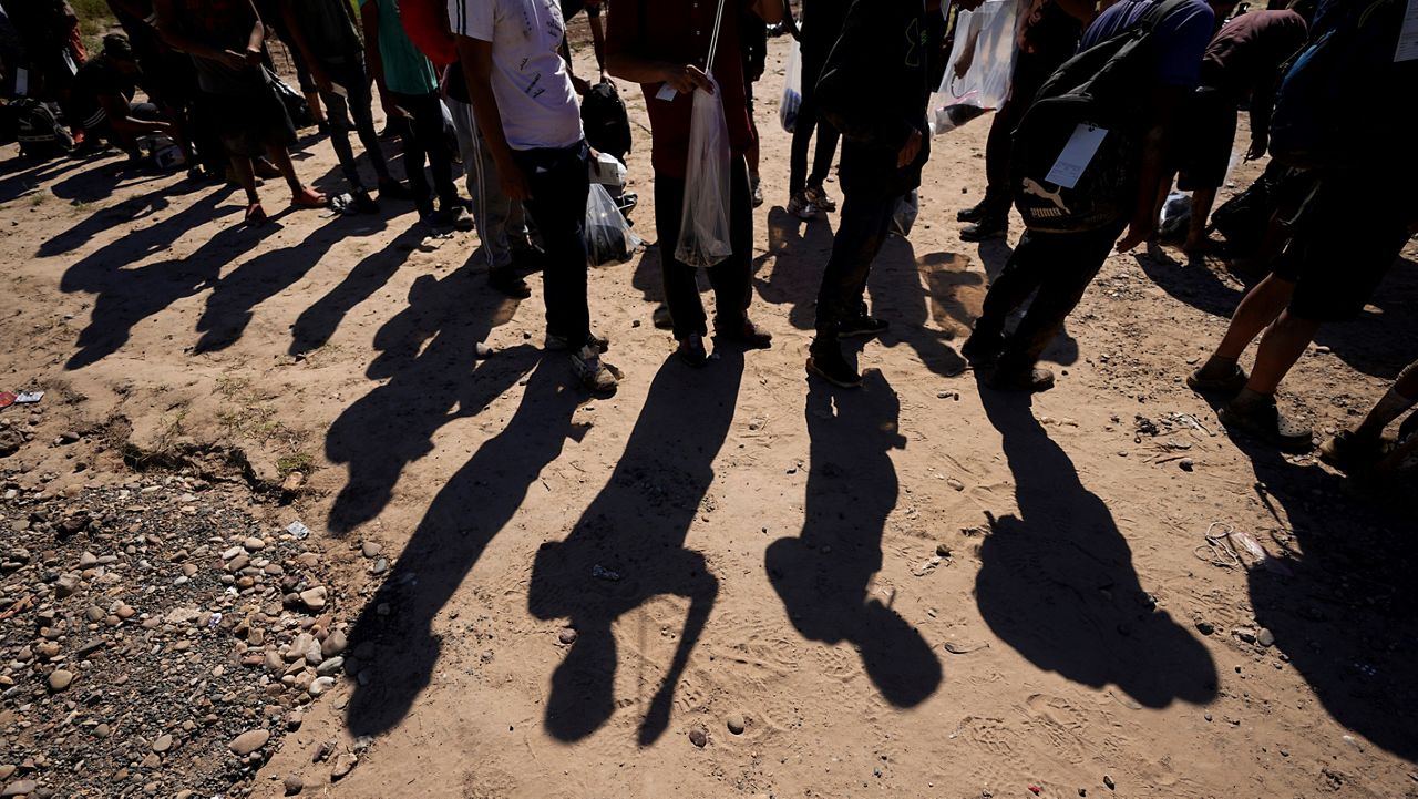 Migrants wait to be processed by the U.S. Customs and Border Patrol after they crossed the Rio Grande and entered the U.S. from Mexico, Oct. 19, 2023, in Eagle Pass, Texas. (AP Photo/Eric Gay, File)