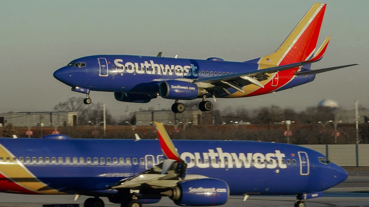 A Southwest Airlines plane prepares to land at Midway International Airport while another taxis on the ground, Feb. 12, 2023, in Chicago. (AP Photo/Kiichiro Sato, File)