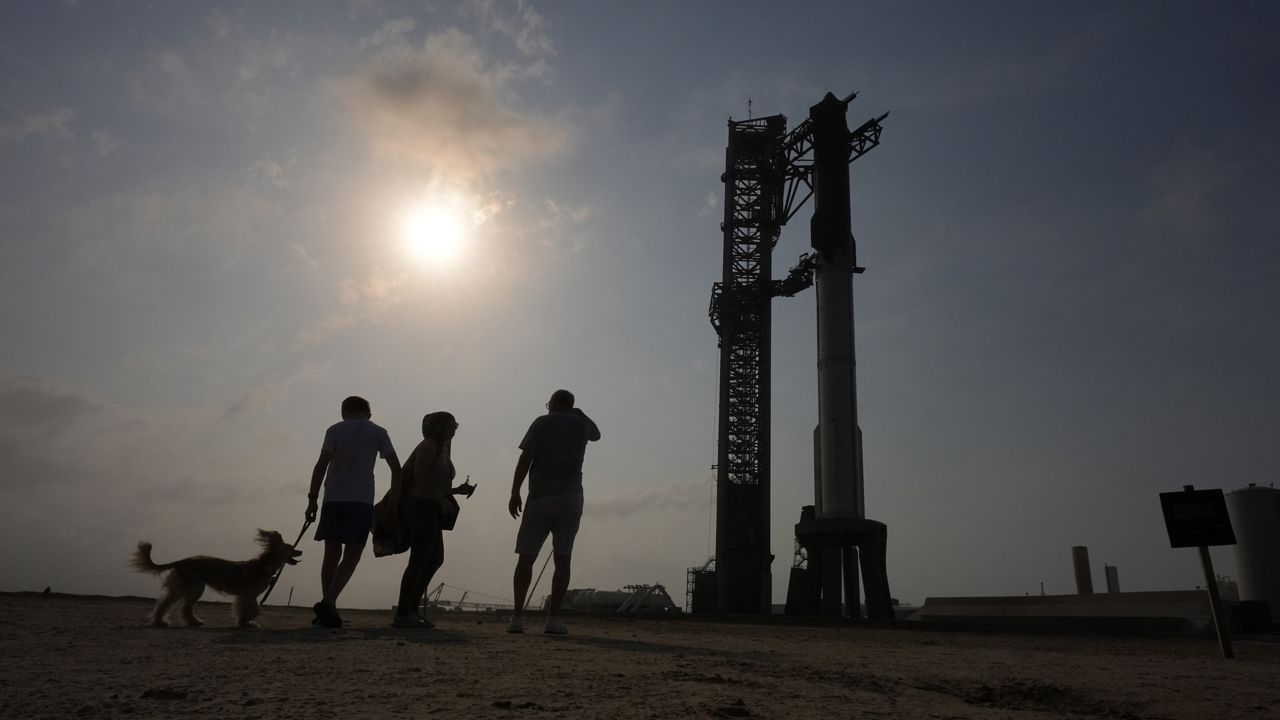 Onlookers watch as SpaceX's mega rocket Starship is prepared for a test flight from Starbase in Boca Chica, Texas, Wednesday, June 5, 2024. (AP Photo/Eric Gay)