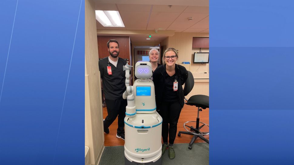 Nurses pose with Moxie robot 