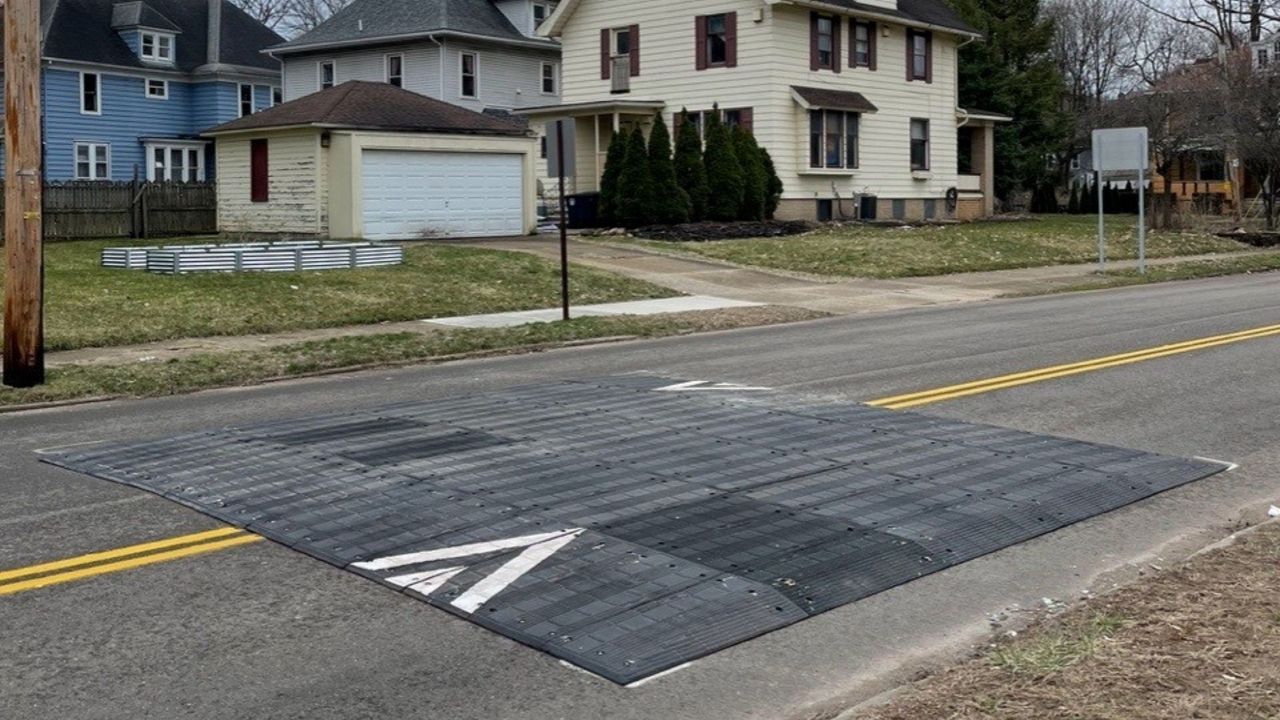 a flat, rubberized speed table installed in a residential Akron street
