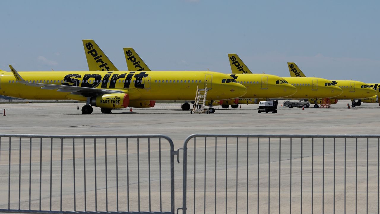 A line of Spirit Airlines jets sit on the tarmac at the Orlando International Airport Wednesday, May 20, 2020, in Orlando, Fla.  (AP Photo/Chris O'Meara)