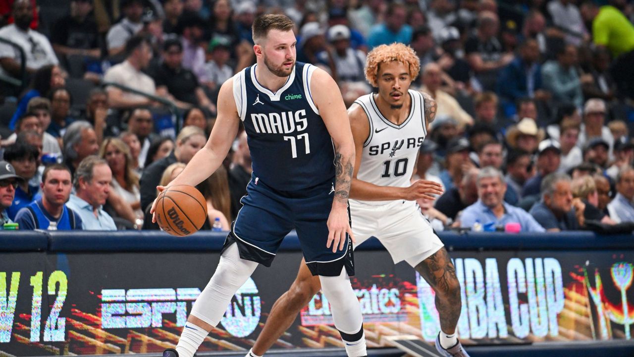 Dallas Mavericks' guard Luka Doncic, left, is defended by San Antonio Spurs forward Jeremy Sochan, right, during the first half of an NBA basketball game, Thursday, Oct. 24, 2024, in Dallas, Texas. (AP Photo/Albert Pena)