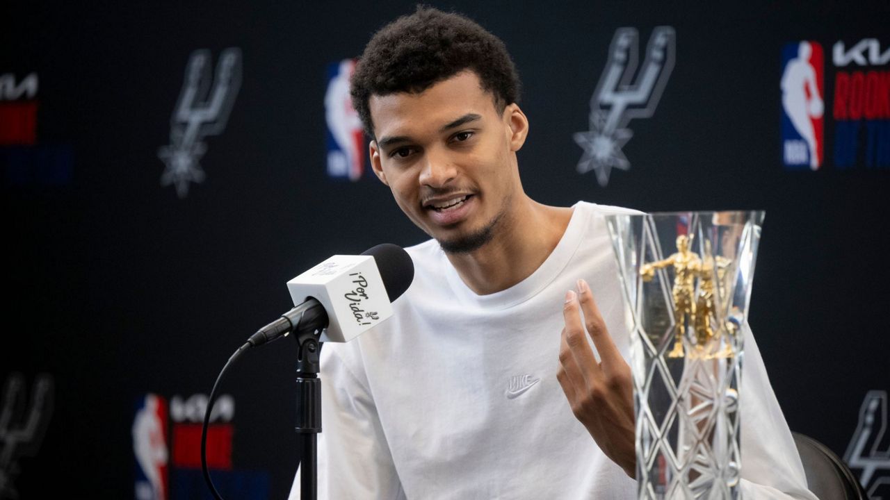 San Antonio Spurs' Victor Wembanyama speaks to media after receiving his 2023-24 NBA Rookie of the Year trophy during an NBA basketball news conference, Saturday, May 11, 2024, in San Antonio. (AP Photo/Darren Abate)