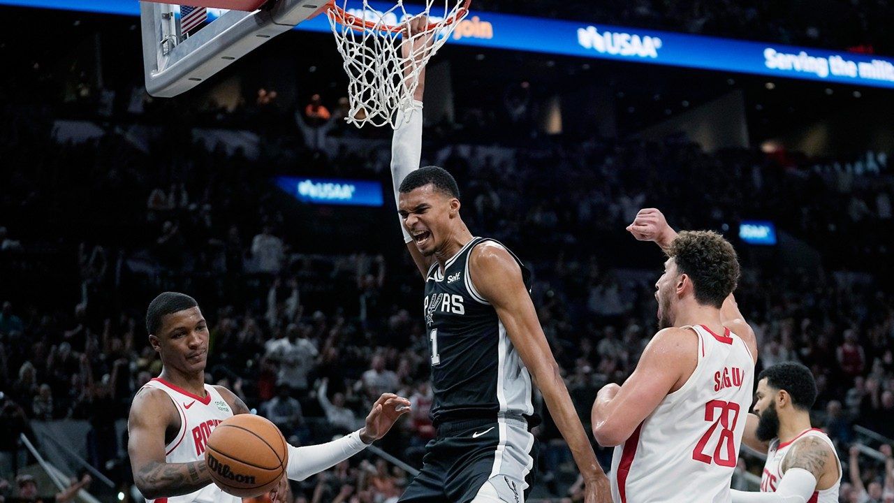 San Antonio Spurs center Victor Wembanyama (1) reacts to a play, between Houston Rockets' Jabari Smith Jr., left, and Alperen Sengun (28) during overtime in an NBA basketball game in San Antonio, Friday, Oct. 27, 2023. (AP Photo/Eric Gay)