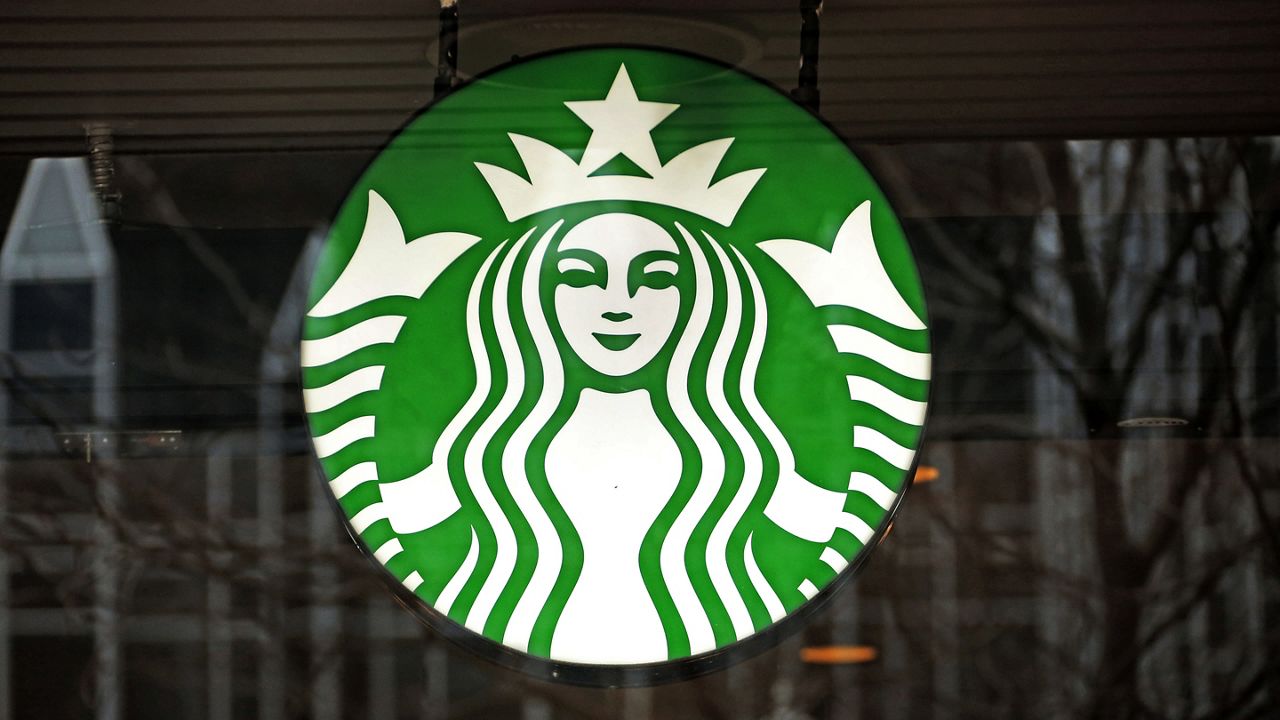 A Starbucks logo sign in the window of one of the chain's cafes in Pittsburgh, Jan. 12, 2017. (AP Photo/Gene J. Puskar, File)