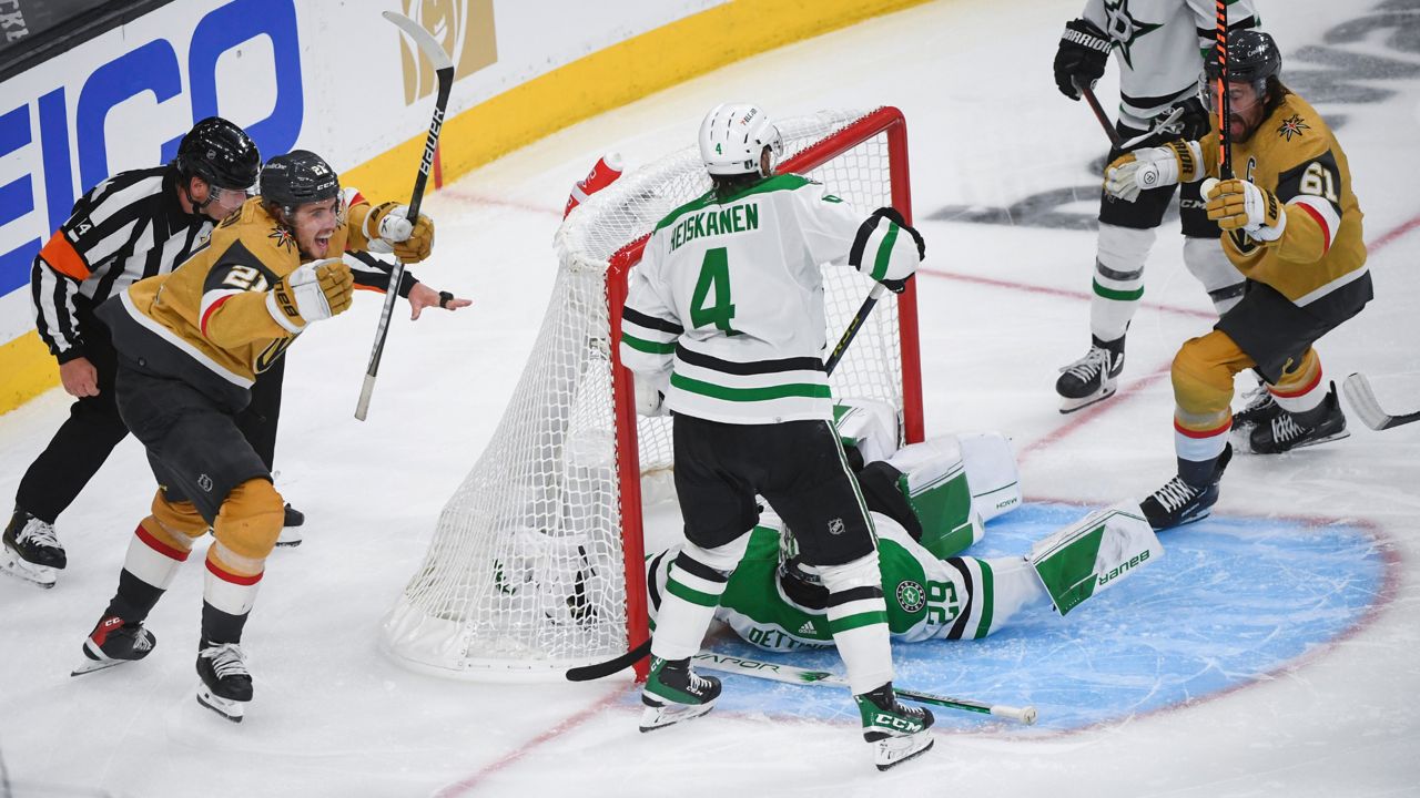 Vegas Golden Knights center Brett Howden (21) celebrates after scoring against Dallas Stars goaltender Jake Oettinger (29) in overtime during Game 1 of the NHL hockey Stanley Cup Western Conference finals Friday, May 19, 2023, in Las Vegas. The Golden Knights won 4-3. (AP Photo/Sam Morris)
