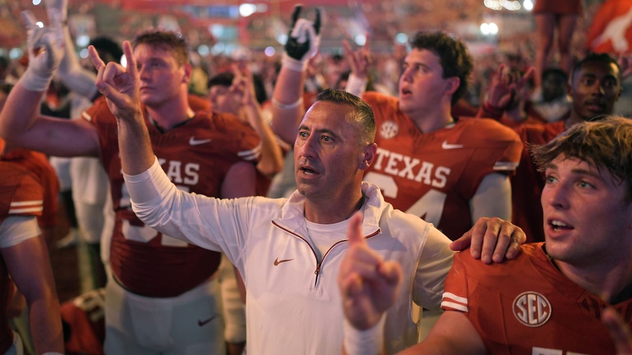 Texas head coach Steve Sarkisian, center, stands with players for the school song following their win over UTSA in an NCAA college football game in Austin, Texas, Saturday, Sept. 14, 2024. (AP Photo/Eric Gay)