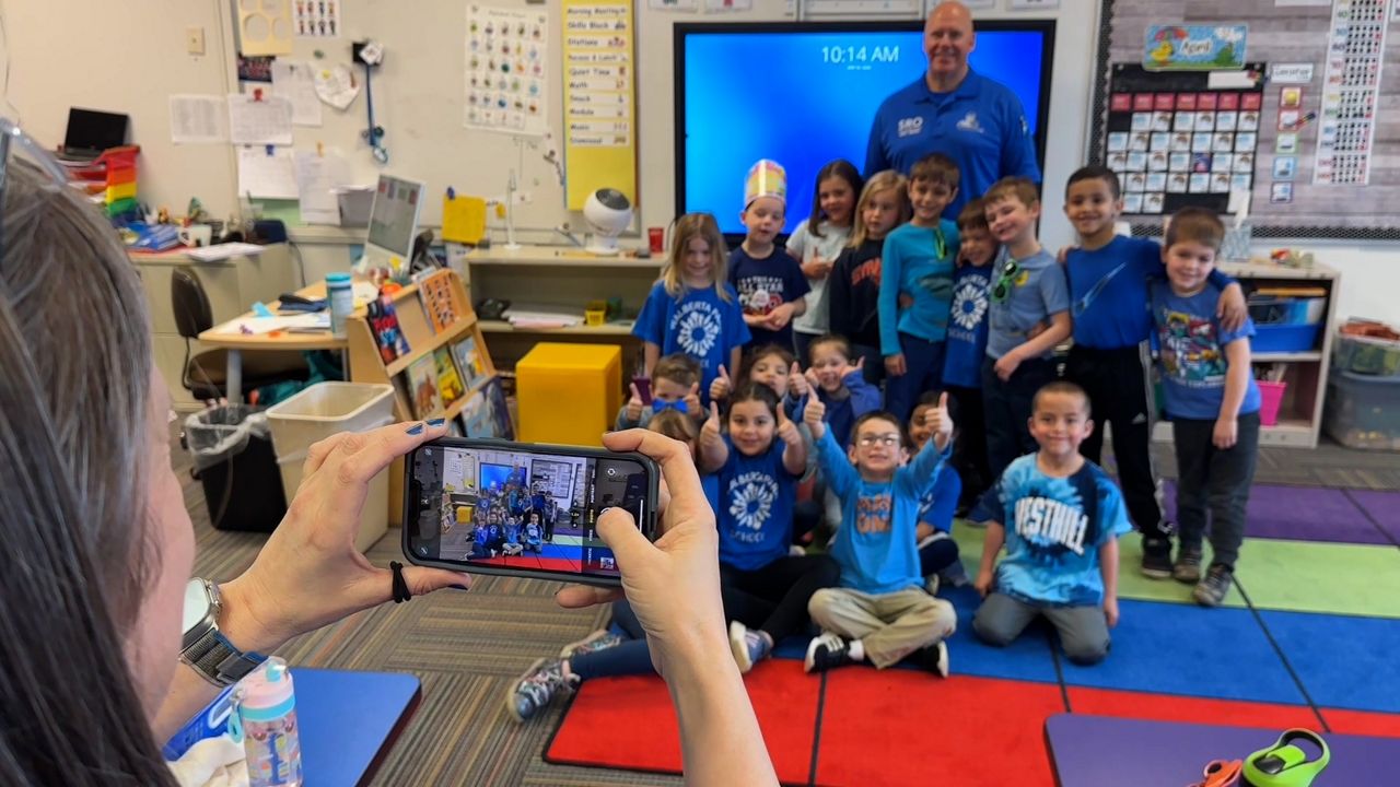 Students have their picture taken as they participate in the 