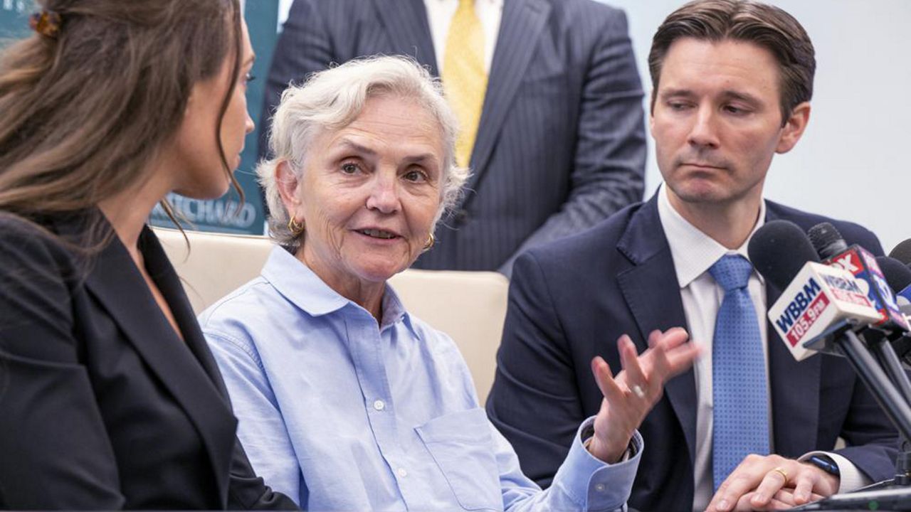 Sue Kamuda, center, and her attorney Patrick Salvi II speak to reporters at the Salvi Schostok and Pritchard law office downtown, Monday, Sept. 19, 2022. A jury has awarded $363 million to a woman who alleged that a now-shuttered suburban Chicago plant that sterilized medical equipment exposed residents to a toxic industrial gas and gave her breast cancer. (Tyler Pasciak LaRiviere/Chicago Sun-Times via AP)