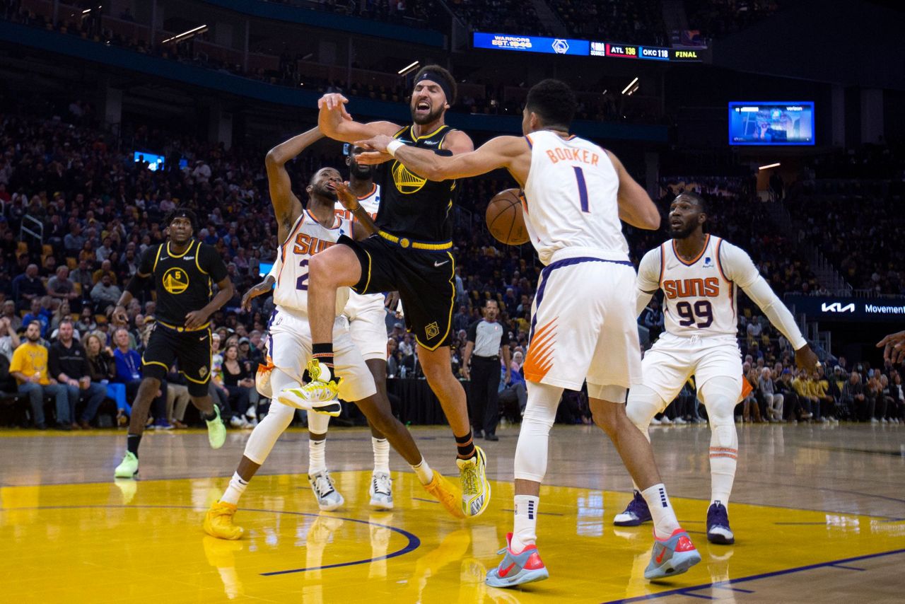 Booker, Paul deliver at end, Suns hold off Warriors 107103