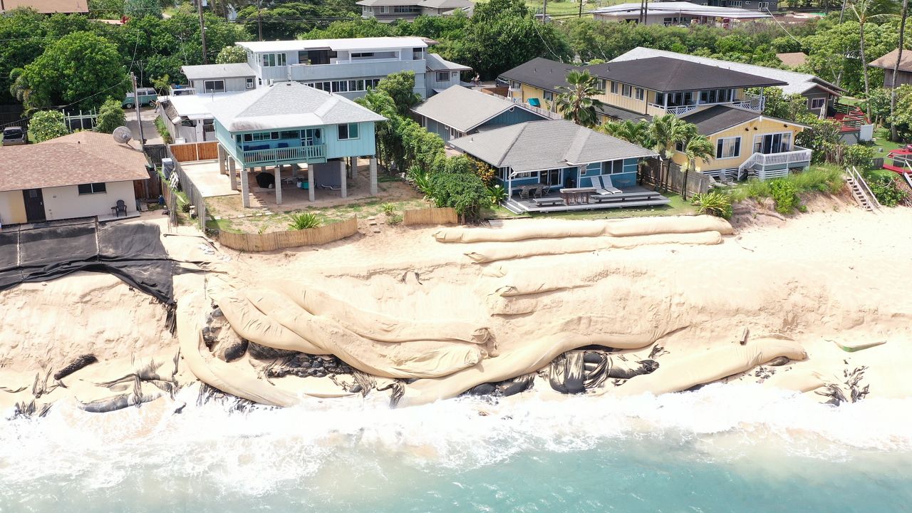 Youman's property (59-149 Ke Nui Road) is the turquoise house on the left, while the Kernots home (59-151 A Ke Nui Road) is the darker blue house on the right. (Photo courtesy of DLNR)