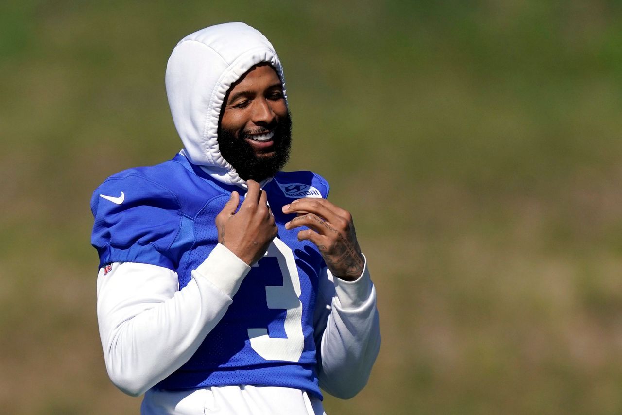 Los Angeles Rams wide receiver Odell Beckham Jr. puts on his helmet during  practice for an NFL …