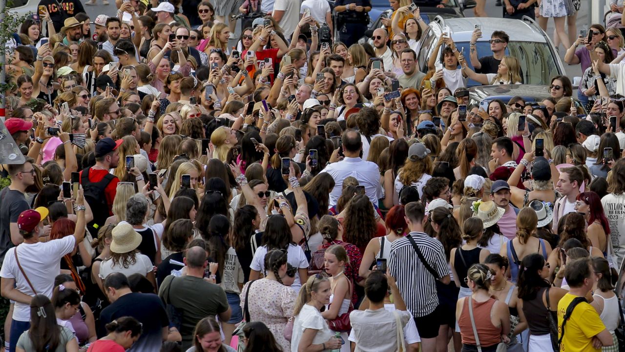 Swifties gather and sing in the city centre in Vienna on Thursday, Aug.8, 2024. (AP Photo/Heinz-Peter Bader)