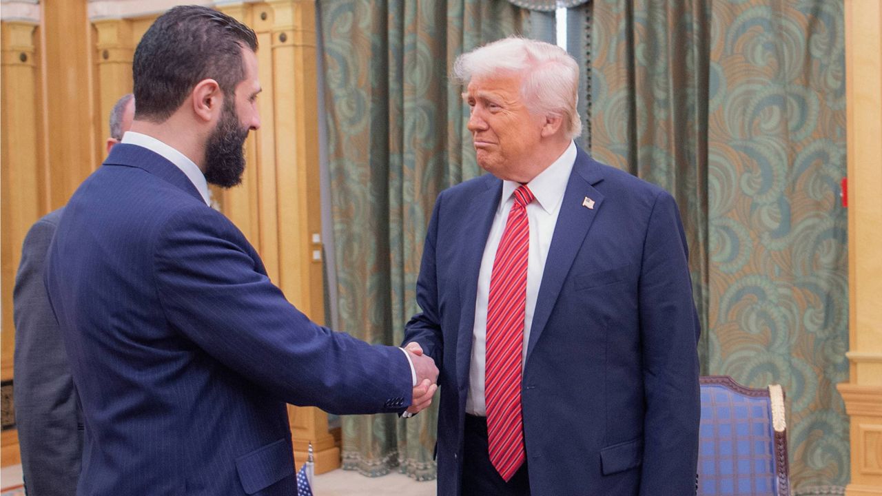 In this photo released by the Saudi Royal Palace, President Donald Trump, right, shakes hands with Syria's interim President Ahmad al-Sharaa, in Riyadh, Saudi Arabia, Wednesday, May 14, 2025. (Bandar Aljaloud/Saudi Royal Palace via AP)