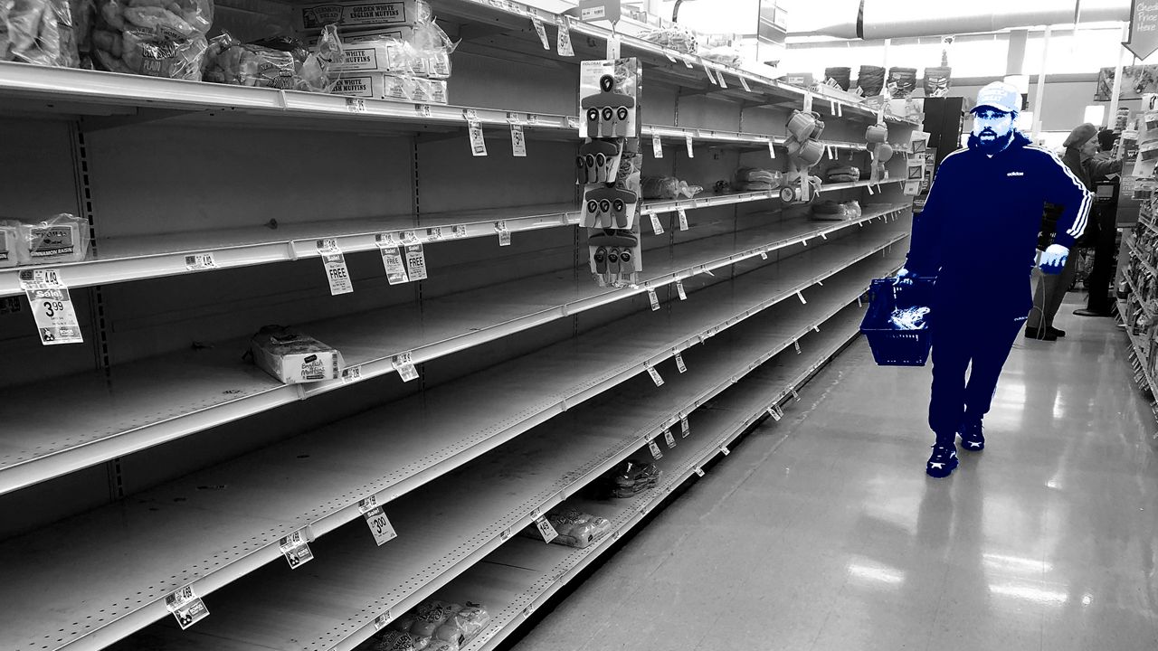 A man walks down an empty bread aisle in a supermarket (AP)