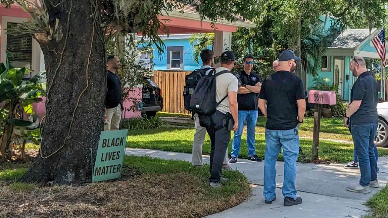 FBI agents gather outside the home of Tampa City Council member Lynn Hurtak Monday afternoon. She says it "appears" that the raid of her home was related to her husband's work as a journalist. (Tampa Bay Times/Justin Garcia)