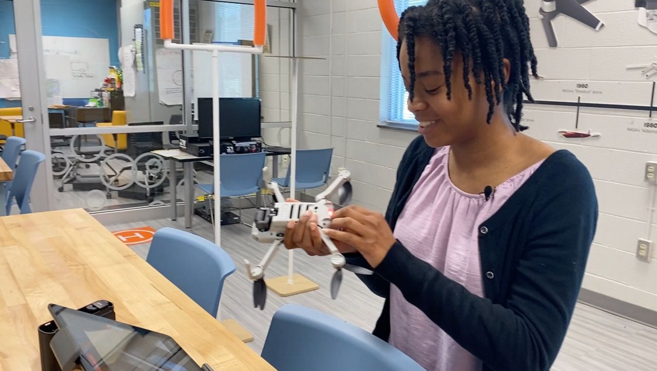 Bailey Wright fixing the processor on the drone