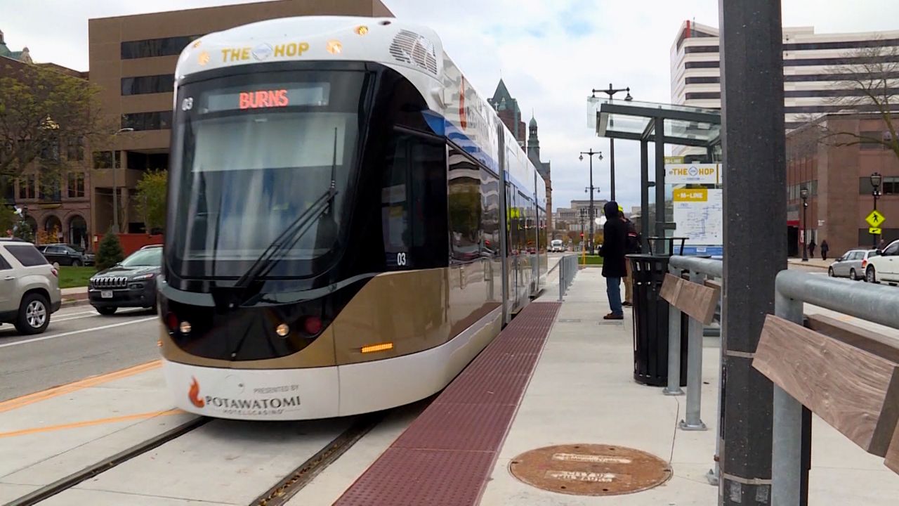 The Hop streetcar arrives at a station