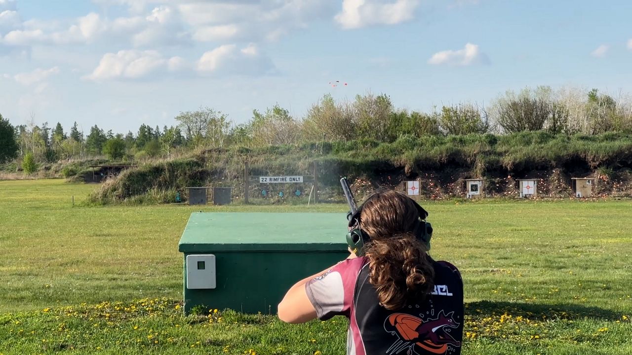 Sage Crubel shooting a clay target at the range