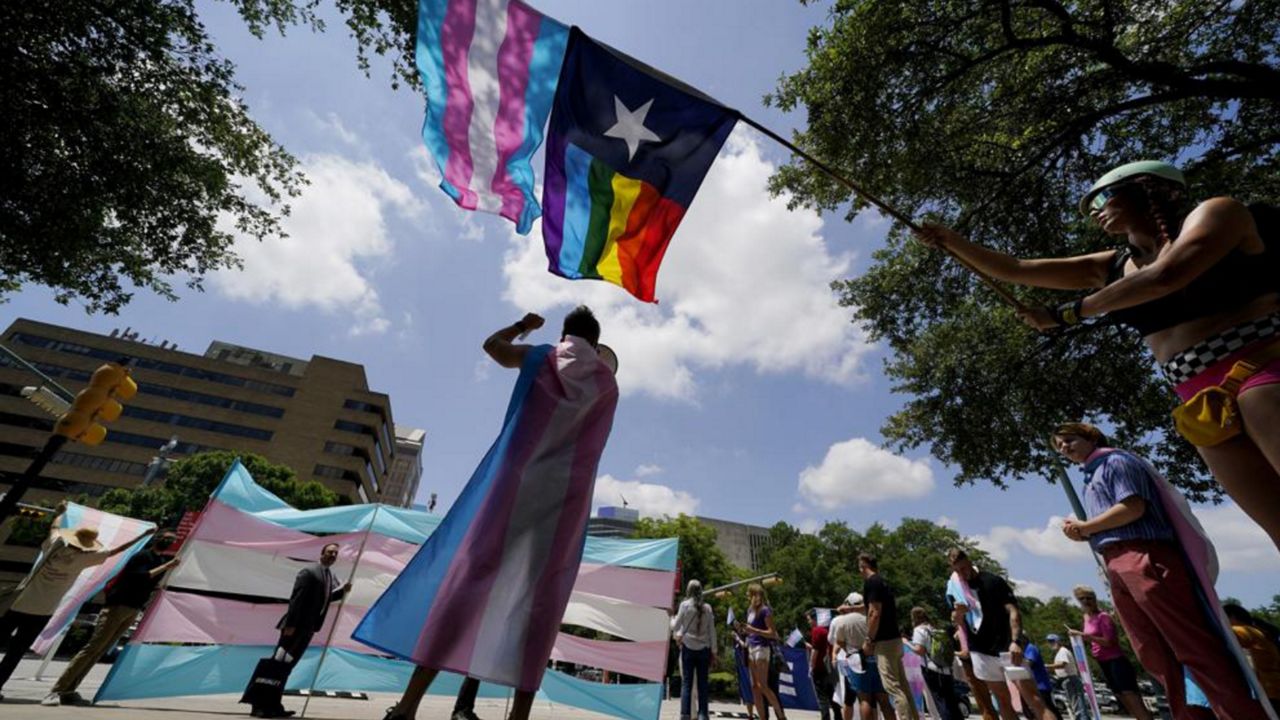 Demonstrators gather on the steps to the State Capitol to speak against transgender-related legislation bills being considered in the Texas Senate and Texas House, May 20, 2021 in Austin, Texas. The Texas Supreme Court is allowing the state to investigate parents of transgender youth for child abuse. But in a mixed ruling Friday, May 13, 2022, the court also handed a victory to one family that was among the first contacted by child welfare officials following an order by Republican Gov. Greg Abbott. (AP Photo/Eric Gay, File)