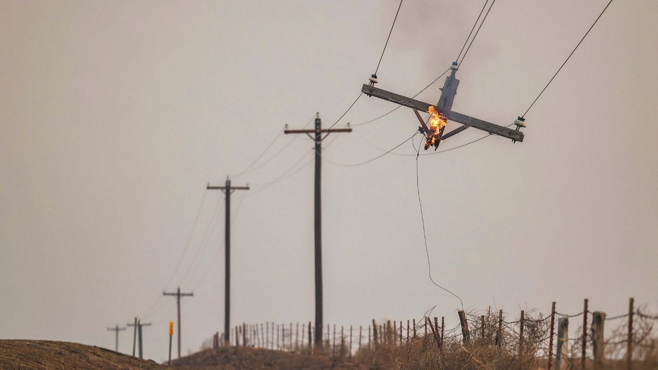 A telephone pole burns from the Smokehouse Creek Fire, Wednesday, Feb. 28, 2024, in Canadian, Texas. (AP Photo/David Erickson)