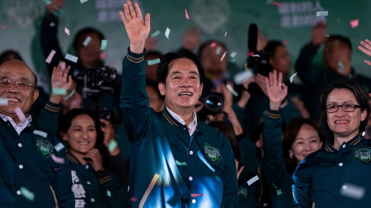 Taiwanese Vice President Lai Ching-te, also known as William Lai, left, celebrates his victory with running mate Bi-khim Hsiao in Taipei, Taiwan, Saturday, Jan. 13, 2024. The Ruling-party candidate has emerged victorious in Taiwan's presidential election and his opponents have conceded. (AP Photo/Louise Delmotte)