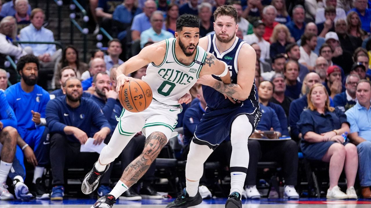 Boston Celtics forward Jayson Tatum, left, drives against Dallas Mavericks guard Luka Doncic during the second half in Game 3 of the NBA basketball finals, Wednesday, June 12, 2024, in Dallas. (AP Photo/Tony Gutierrez)