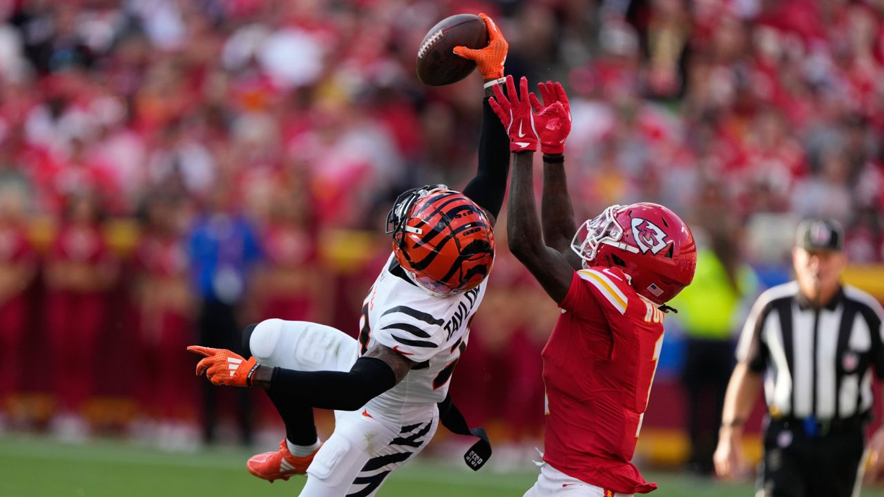 Cincinnati Bengals cornerback Cam Taylor-Britt, left, intercepts a pass intended for Kansas City Chiefs wide receiver Xavier Worthy during the second half of an NFL football game Sunday, Sept. 15, 2024, in Kansas City, Mo. 