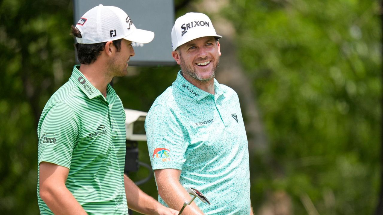 Taylor Pendrith, right, laughs with fellow competitor Davis Riley, left, at the second hole tee box during the third round of the Byron Nelson golf tournament in McKinney, Texas, Saturday, May 4, 2024. (AP Photo/LM Otero)