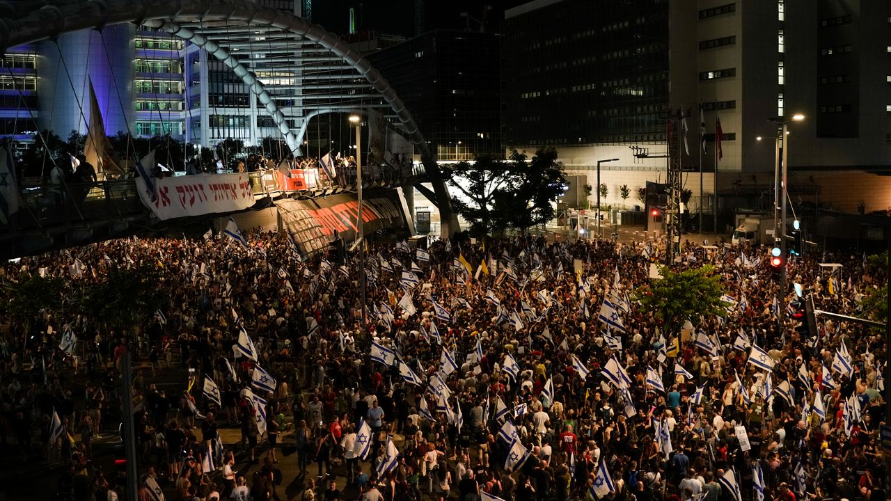 People protest against Israeli Prime Minister Benjamin Netanyahu's government and call for the release of hostages held in the Gaza Strip by the Hamas militant group, in Tel Aviv, Israel, Saturday, June 22, 2024. (AP Photo/Leo Correa)