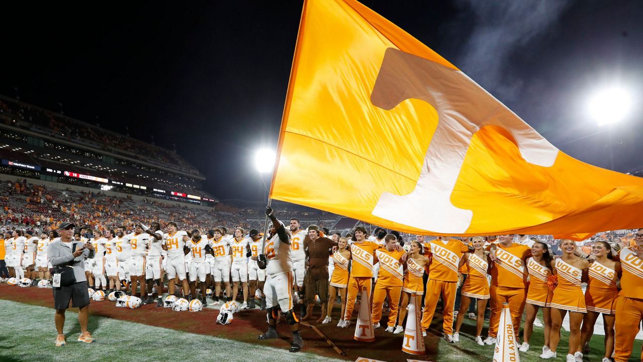 Tennessee offensive lineman Javontez Spraggins (76) waves a giant Tennessee flag after his team defeated Oklahoma in an NCAA college football game Saturday, Sept. 21, 2024, in Norman, Okla. (AP Photo/Alonzo Adams)