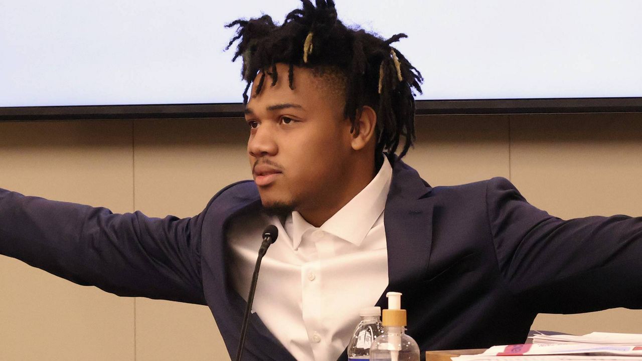 University of Illinois basketball standout Terrence Shannon Jr. demonstrates his wingspan while testifying during his rape trial Thursday June 13, 2024, in Lawrence, Kan. Shannon, of Champaign, Ill., is accused of committing sexual assault on Sept. 9, 2023, in Lawrence, Kan. (Chris Conde/The Lawrence Journal-World via AP)