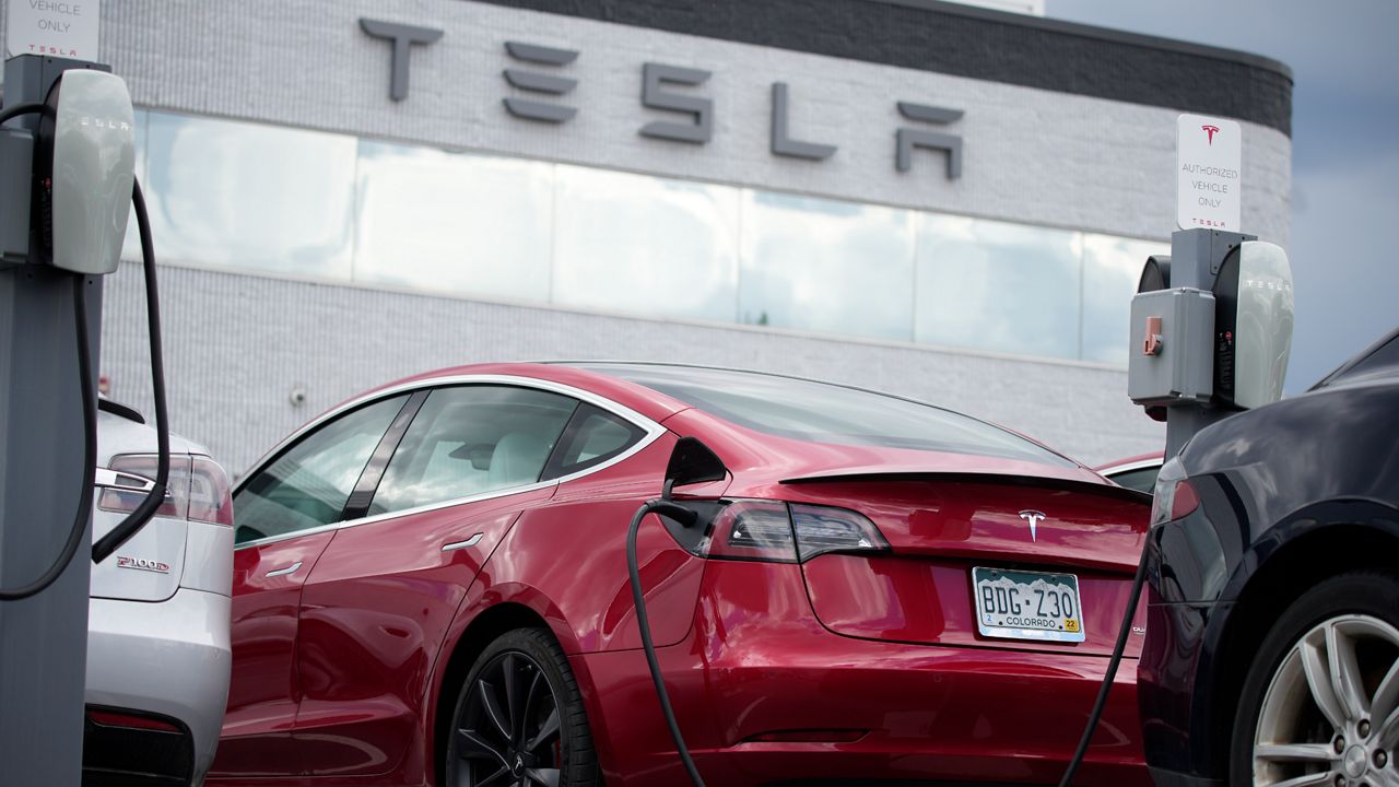 In this Sunday, June 27, 2021, photograph, a 2021 Model 3 sedan sits in a near-empty lot at a Tesla dealership in Littleton, Colo. (AP Photo/David Zalubowski)