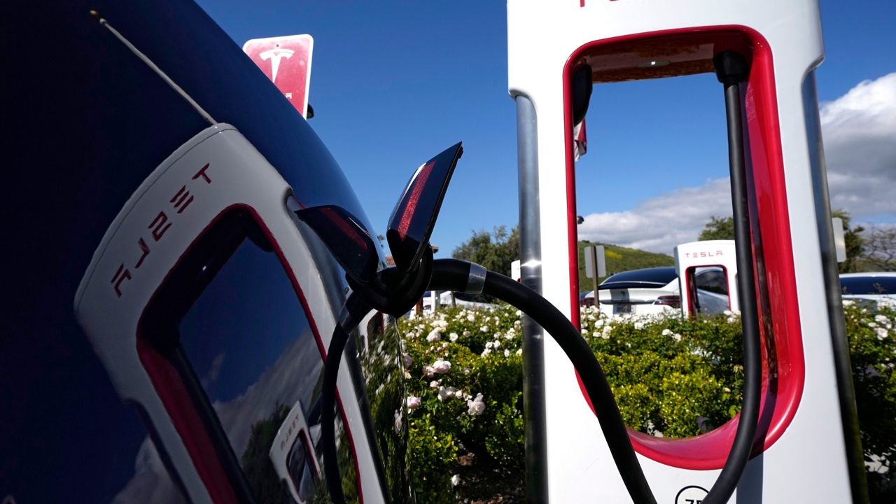 A Tesla auto charges on May 10, 2023, in Westlake, Calif. All of Ford Motor Co.'s current and future electric vehicles will have access to about 12,000 Tesla Supercharger stations starting in 2024, according to an announcement Thursday, May 25, 2023, by Ford CEO Jim Farley and Tesla CEO Elon Musk. (AP Photo/Mark J. Terrill, File)