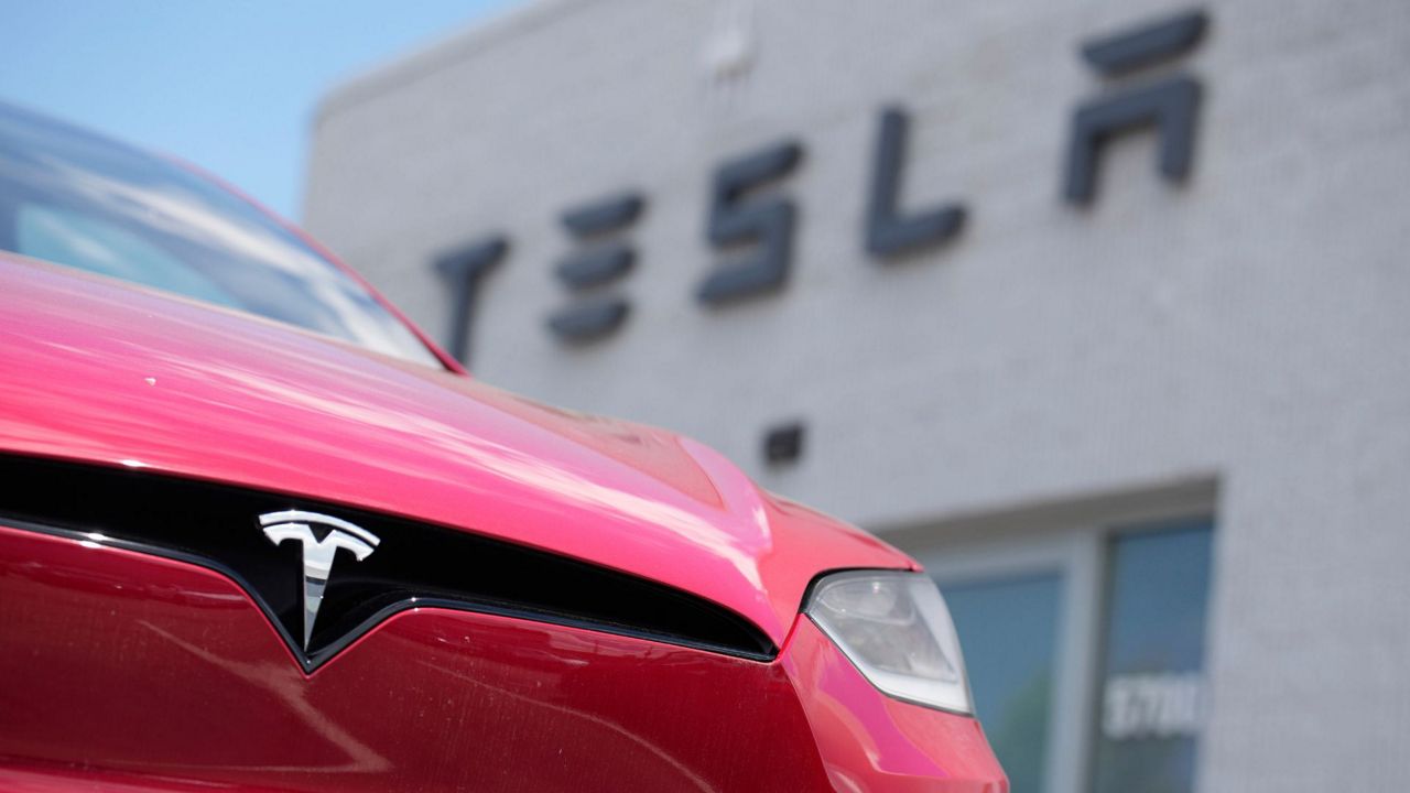 A Model X sports-utility vehicle sits outside a Tesla store in Littleton, Colo., on June 18, 2023. (AP Photo/David Zalubowski, File)