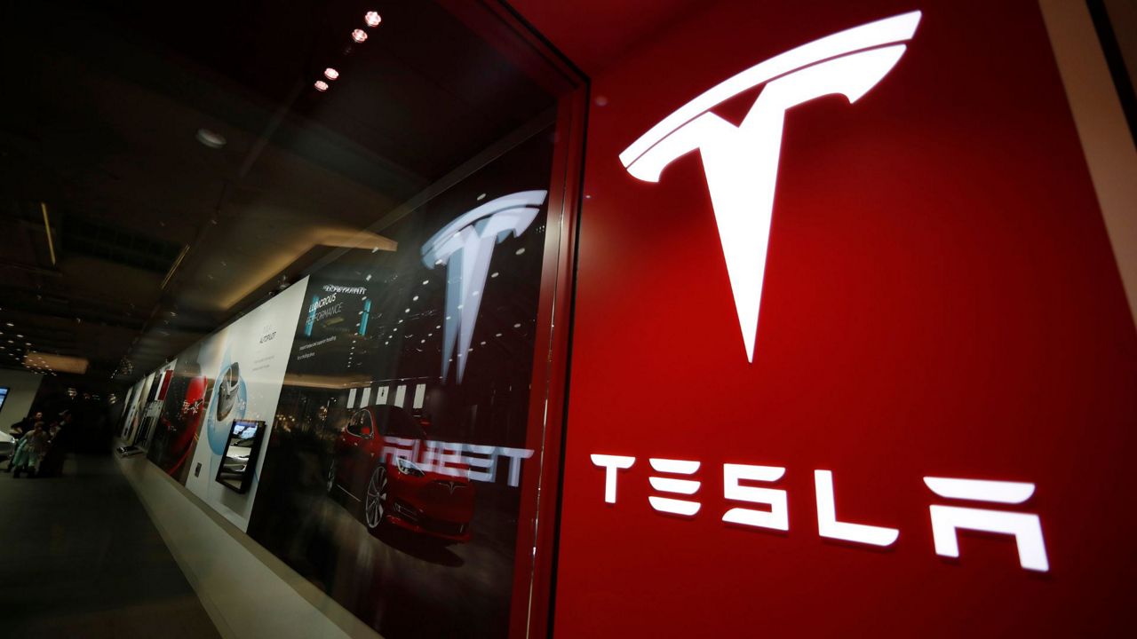 The Tesla logo is displayed at the company's store in Cherry Creek Mall, Feb. 9, 2019, in Denver. (AP Photo/David Zalubowski, File)