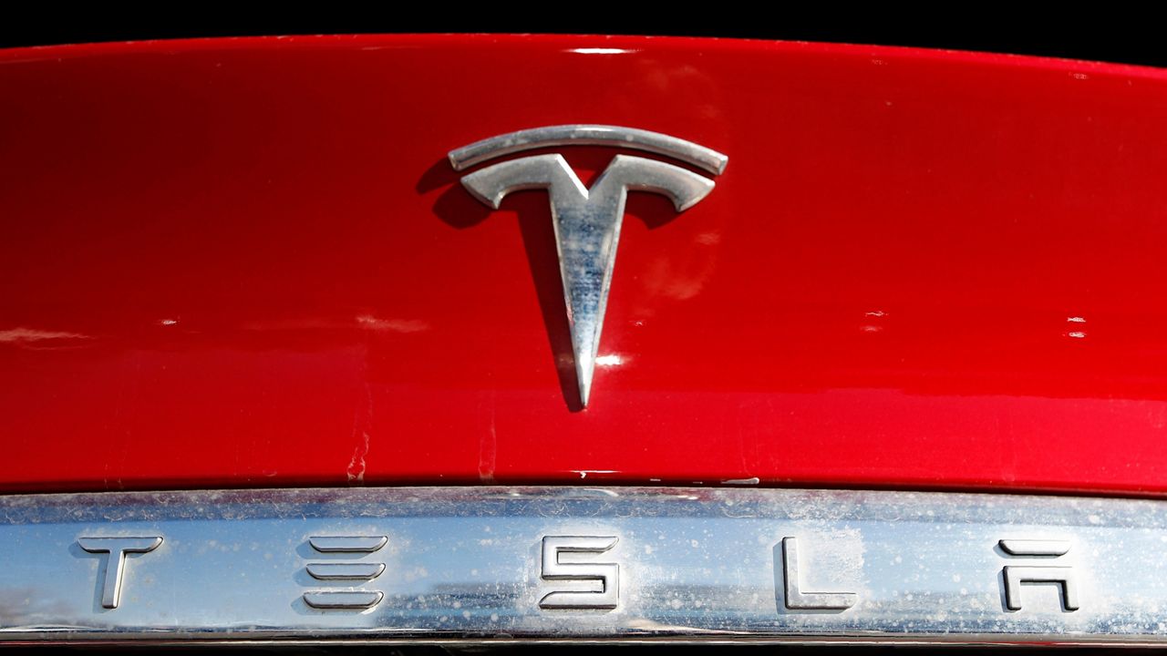 The Tesla company logo is shown at a Tesla dealership in Littleton, Colo. Feb. 2, 2020. Tesla said in its safety recall report that is recalling nearly 16,000 of its 2021-2023 Model S and Model X vehicles because some front-row seat belts may not have been reconnected properly following a repair. (AP Photo/David Zalubowski, File)