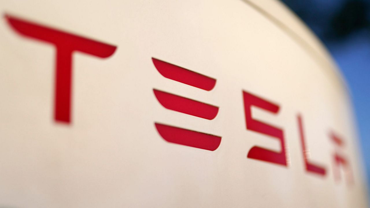 The logo for the Tesla Supercharger station is seen in Buford, Ga, April 22, 2021. Faced with falling global sales and a tumbling stock price, Tesla has slashed prices again on some of its electric vehicles and its “Full Self Driving” system. Tesla releases first-quarter earnings Tuesday, April 23, 2024. (AP Photo/Chris Carlson, File)