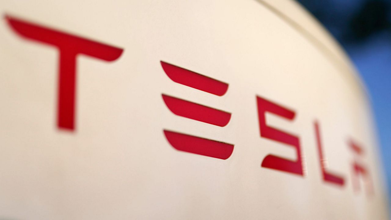 The logo for the Tesla Supercharger station is seen in Buford, Ga, April 22, 2021. (AP Photo/Chris Carlson, File)