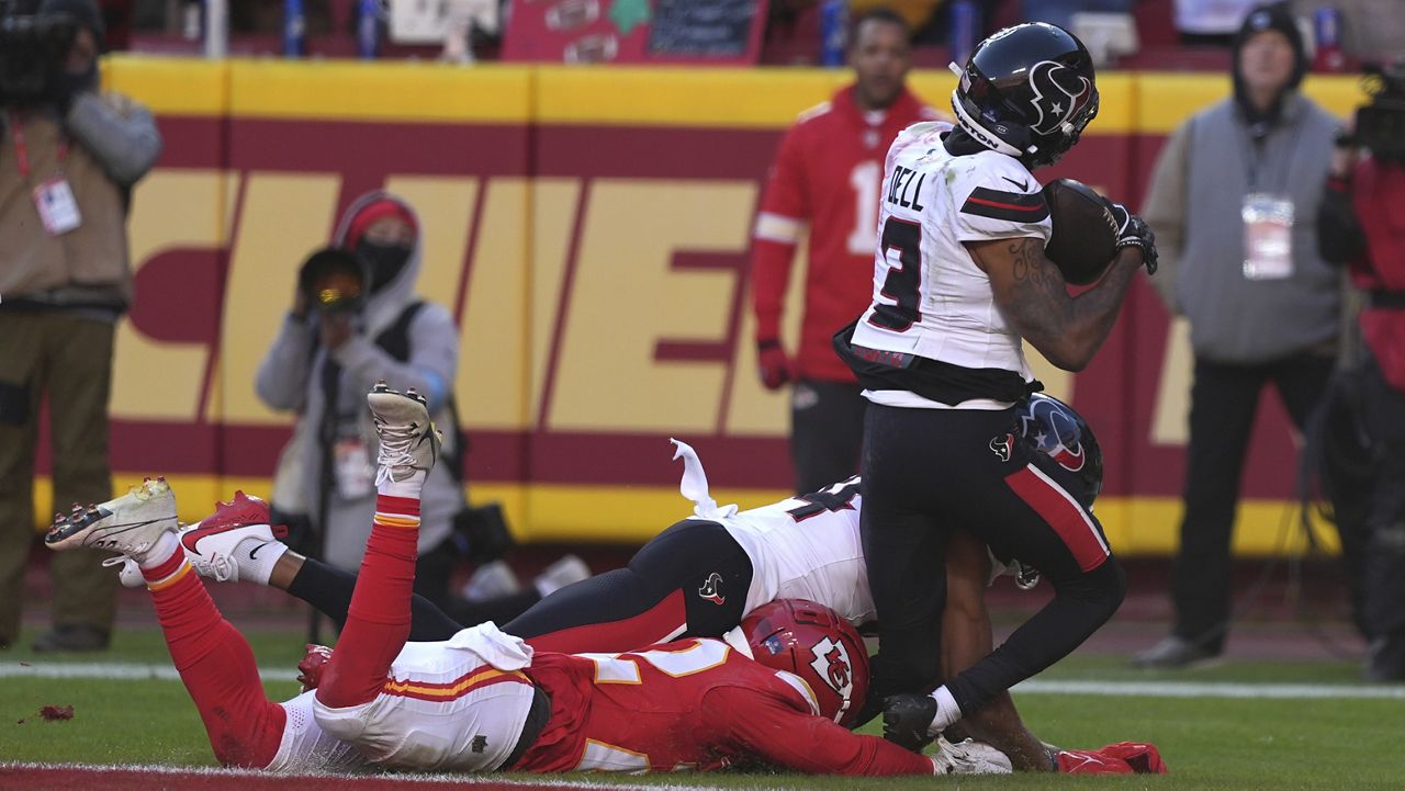 Houston Texans wide receiver Tank Dell (3) catches a touchdown pass as Kansas City Chiefs cornerback Trent McDuffie, left, defends during the second half of an NFL football game Saturday, Dec. 21, 2024, in Kansas City, Mo. Dell was injured on the play. (AP Photo/Charlie Riedel)