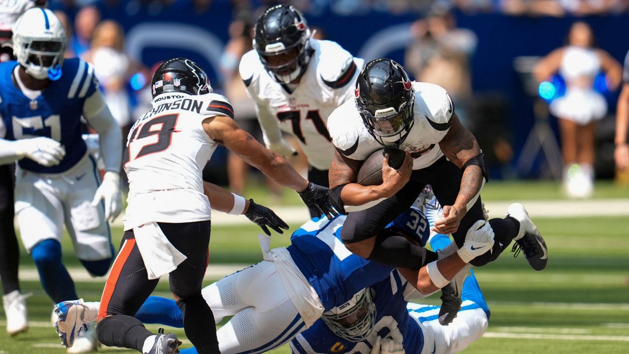 Indianapolis Colts safety Julian Blackmon (32) tackles Houston Texans running back Joe Mixon (28) during the second half of an NFL football game, Sunday, Sept. 8, 2024, in Indianapolis. (AP Photo/Michael Conroy)